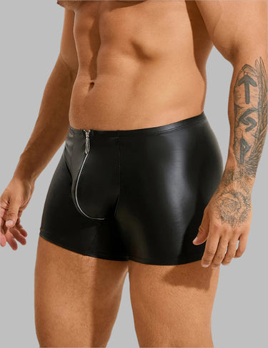 a man with a tattoo on his arm wearing black leather shorts